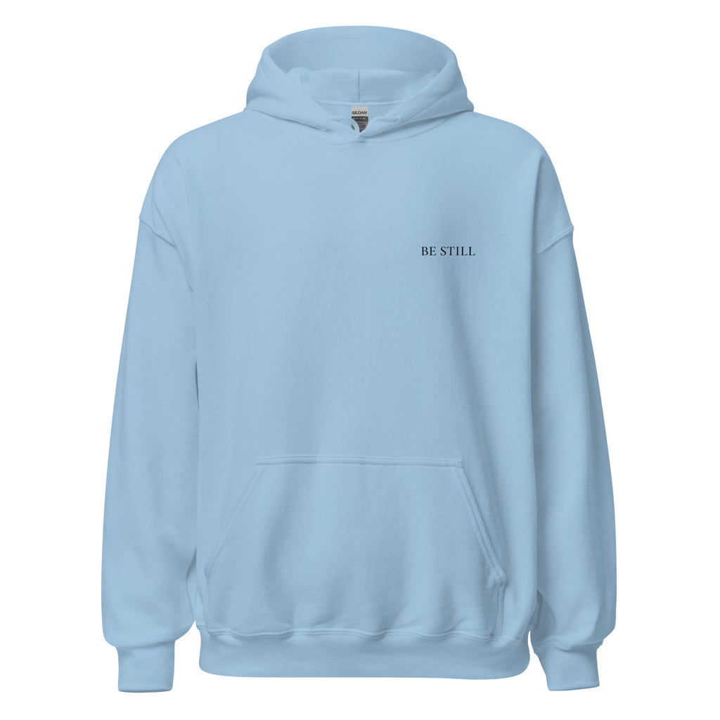 Light blue heavy blend fleece hoodie with small chest BE STILL quote, front view