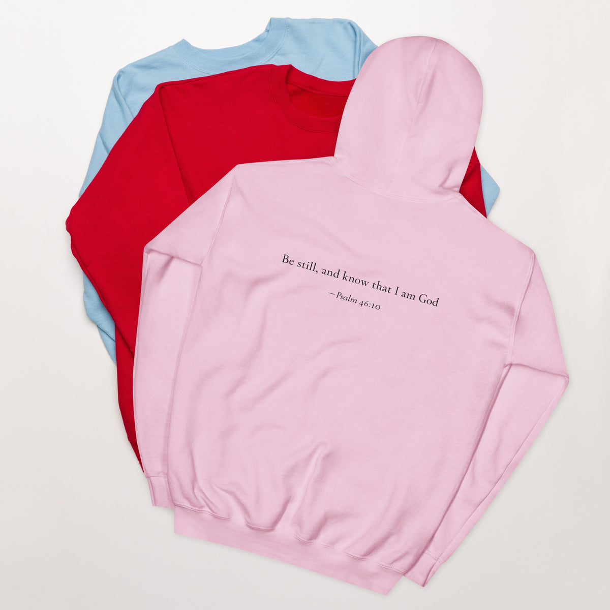 Light pink heavy blend fleece hoodie with small chest BE STILL quote, back detail