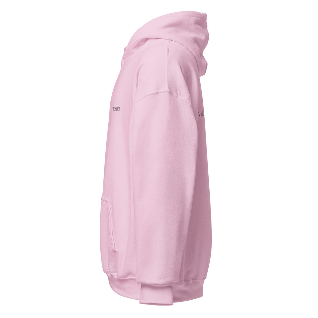 Light pink heavy blend fleece hoodie with small chest BE STILL quote, left side view
