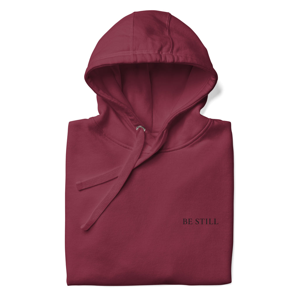 Maroon premium pullover hoodie with small chest BE STILL quote, front detail