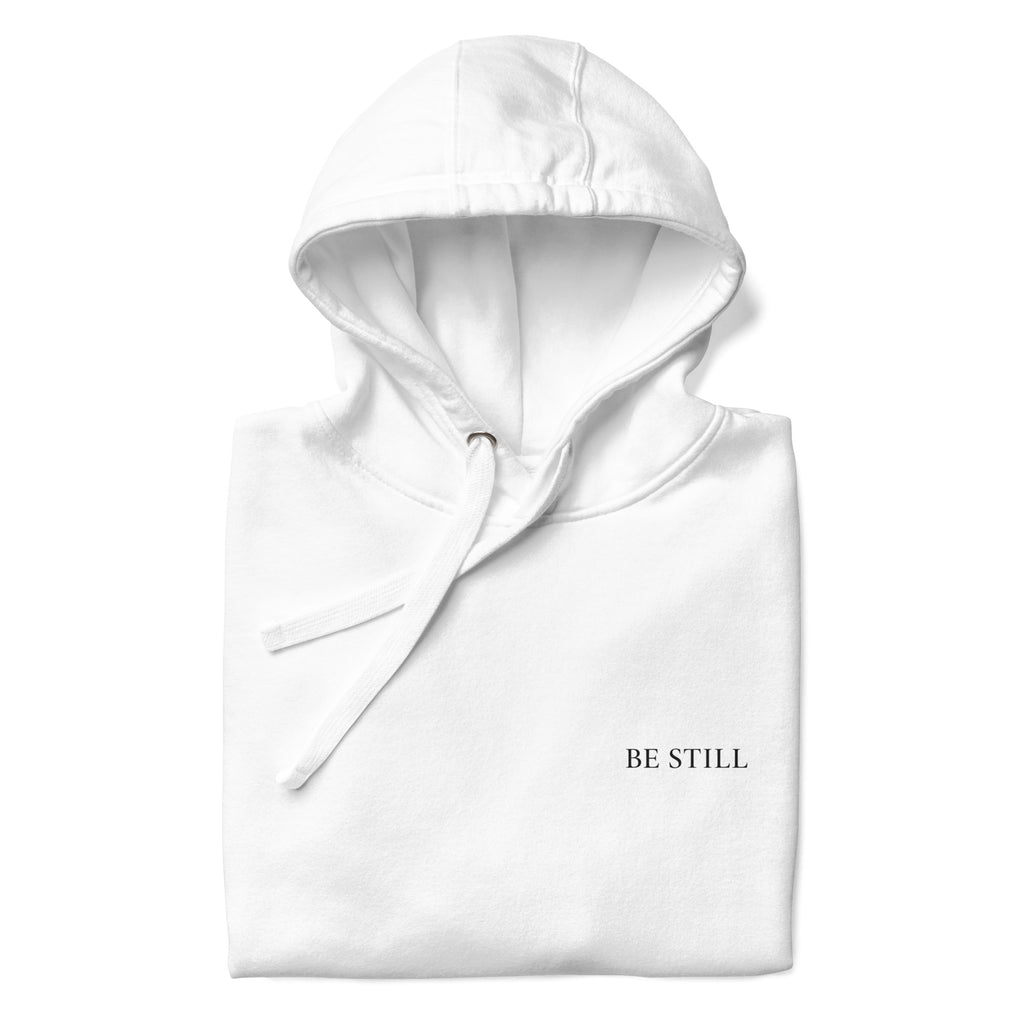White premium pullover hoodie with small chest BE STILL quote, front detail